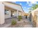 This outdoor patio features neutral tones with a patterned brick floor and desert landscaping at 6033 Torciano St, North Las Vegas, NV 89081