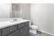 Bathroom features a modern vanity with storage and a toilet at 6033 Torciano St, North Las Vegas, NV 89081