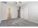 Spacious bedroom with plush carpet, ceiling fan, closet, and ensuite bathroom access at 6033 Torciano St, North Las Vegas, NV 89081