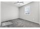 Bedroom features plush carpet, bright natural light, and a modern ceiling fan at 6033 Torciano St, North Las Vegas, NV 89081