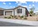 Charming single-story home with a two-car garage and desert landscaping in front yard at 6033 Torciano St, North Las Vegas, NV 89081