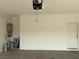 Spacious two-car garage featuring a water heater, garage door opener, and clean concrete flooring at 6033 Torciano St, North Las Vegas, NV 89081
