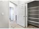 Hallway with wood-look flooring leading to multiple rooms and closet with shelving at 6033 Torciano St, North Las Vegas, NV 89081