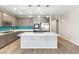 Modern kitchen featuring a large island, stainless steel appliances, and beautiful pendant lighting at 6033 Torciano St, North Las Vegas, NV 89081