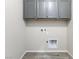 Functional laundry room boasts overhead cabinets and modern utility connections at 6033 Torciano St, North Las Vegas, NV 89081