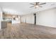 Open-concept living room and kitchen with wood-look tile flooring and modern lighting at 6033 Torciano St, North Las Vegas, NV 89081