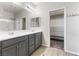 Main bathroom with double vanity, walk-in closet, and glass-enclosed shower at 6033 Torciano St, North Las Vegas, NV 89081