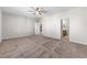 Spacious main bedroom with neutral carpet, ceiling fan, and adjacent bathroom at 6033 Torciano St, North Las Vegas, NV 89081