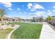 This community park has new homes, playground equipment, lots of grass, and trees at 6033 Torciano St, North Las Vegas, NV 89081