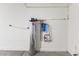 This utility room shows a water filtration system and plumbing on a white wall in the basement at 6033 Torciano St, North Las Vegas, NV 89081
