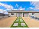 Spacious backyard featuring desert landscaping with a stepping stone pathway and patio seating area at 6101 Cavalry Trl, Pahrump, NV 89060