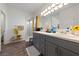 Bathroom featuring a gray vanity, large mirror with modern lighting, with a shower and a shelf at 6101 Cavalry Trl, Pahrump, NV 89060