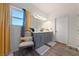 Bright bathroom featuring gray vanity cabinets, white countertop, chair, and modern fixtures at 6101 Cavalry Trl, Pahrump, NV 89060