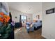 Bedroom with a comfortable bed, patterned bedding, plants, and an armchair at 6101 Cavalry Trl, Pahrump, NV 89060