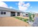 Rear exterior showing covered patio, pool access, manicured landscaping and mountain views at 6101 Cavalry Trl, Pahrump, NV 89060