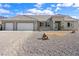 Attractive single-story home with a three-car garage, desert landscaping, and inviting curb appeal at 6101 Cavalry Trl, Pahrump, NV 89060
