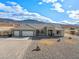 Charming single-story home with a neutral exterior, desert landscaping, and a three-car garage at 6101 Cavalry Trl, Pahrump, NV 89060