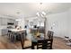 Bright kitchen with gray cabinets, stainless steel appliances, a kitchen island and a glass dining table at 6101 Cavalry Trl, Pahrump, NV 89060