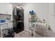Functional laundry room with stacked washer and dryer, shelving, a sink, and ample storage space at 6101 Cavalry Trl, Pahrump, NV 89060