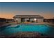 Stunning backyard featuring a refreshing pool, lounge area, and desert landscape with mountain views at 6101 Cavalry Trl, Pahrump, NV 89060
