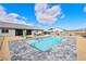 Sparkling pool with stone coping surrounded by patio area, xeriscaping, and home exterior at 6101 Cavalry Trl, Pahrump, NV 89060