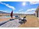 Backyard pool area features a lounge area with mountain views and manicured landscaping at 6101 Cavalry Trl, Pahrump, NV 89060