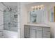 Modern bathroom showcasing marble-look tile shower, large mirror, updated lighting, and neutral vanity at 6109 W Oakey Blvd # C, Las Vegas, NV 89146