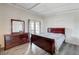 Bedroom with dark wood furniture and access to private patio providing natural light and charm at 6109 W Oakey Blvd # C, Las Vegas, NV 89146