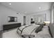 Staged bedroom featuring modern décor, a large TV, plush bedding, and convenient mirrored closet doors at 6109 W Oakey Blvd # C, Las Vegas, NV 89146