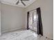 Dining area with tile floors, ceiling fan, and curtains leading to a balcony at 6109 W Oakey Blvd # C, Las Vegas, NV 89146