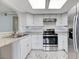 Well lit kitchen featuring stainless steel appliances and tile floors at 6109 W Oakey Blvd # C, Las Vegas, NV 89146