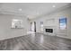 Bright living room featuring a fireplace, wood floors, and plenty of natural light at 6109 W Oakey Blvd # C, Las Vegas, NV 89146
