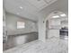 A bright living room featuring seamless flow to the kitchen, sleek flooring, and ample natural light at 6109 W Oakey Blvd # C, Las Vegas, NV 89146