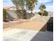 Backyard featuring gravel landscaping, a concrete patio, and mature trees for added privacy at 6119 Magic Mesa St, North Las Vegas, NV 89031