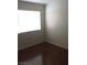 Simple bedroom design featuring hard wood floors, bright white walls, and a large, sunny window at 6119 Magic Mesa St, North Las Vegas, NV 89031