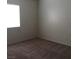 This bedroom features neutral walls, plush carpeting, and a window at 6119 Magic Mesa St, North Las Vegas, NV 89031