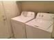 Convenient laundry room equipped with a washer and dryer at 6119 Magic Mesa St, North Las Vegas, NV 89031