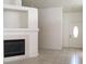 Open living room featuring neutral walls, tiled floors, a fireplace, and a door leading to the exterior at 6119 Magic Mesa St, North Las Vegas, NV 89031