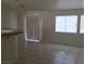 Bright living space featuring tiled floors and plenty of natural light streaming in from the windows at 6119 Magic Mesa St, North Las Vegas, NV 89031