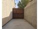 Narrow side yard with concrete path and secure metal and wood gate at 6119 Magic Mesa St, North Las Vegas, NV 89031