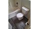 Bathroom featuring a white toilet and bathtub with gray wood-look flooring at 6425 Extreme Shear Ave # 101, Henderson, NV 89011
