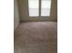 This is a spacious bedroom with plush carpeting and natural light from the window at 6425 Extreme Shear Ave # 101, Henderson, NV 89011