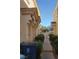 Townhome exterior featuring walkway between buildings and mature landscaping at 6425 Extreme Shear Ave # 101, Henderson, NV 89011