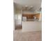 Open floor plan featuring kitchen with bar top, carpet, and tile at 6425 Extreme Shear Ave # 101, Henderson, NV 89011