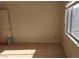 Comfortable bedroom with neutral paint, carpet floor, closet, and window with view of the outside at 664 Sky Rd, Indian Springs, NV 89018