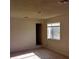 Bright bedroom with neutral paint, carpet floor, closet, and window with view of the outside at 664 Sky Rd, Indian Springs, NV 89018