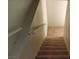 Carpeted stairway featuring white banister at 664 Sky Rd, Indian Springs, NV 89018