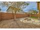 Backyard offers desert landscaping, stone accents, lawn, and privacy fence at 6655 Little Owl Pl, North Las Vegas, NV 89084