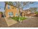 Backyard featuring artificial lawn, desert landscaping, and rock detail with privacy fence at 6655 Little Owl Pl, North Las Vegas, NV 89084