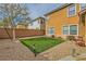 Low-maintenance backyard with artificial turf, rock landscaping, and modern outdoor lighting fixtures at 6655 Little Owl Pl, North Las Vegas, NV 89084